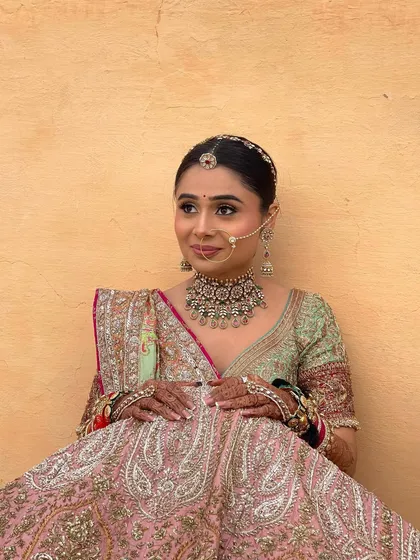 The bride's final look for one of her wedding events. The sleek, center parted front is balanced by the intricate braid at the back.