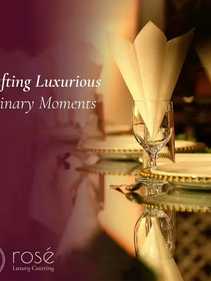 Crafting luxurious culinary moments. A beautifully folded napkin in a wine glass on a mirrored table reflects the elegant atmosphere we strive to create at every event.