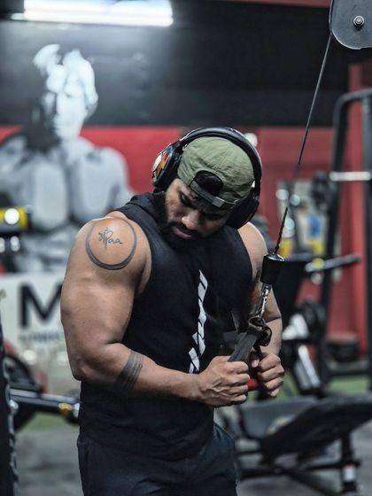 Triceps pushdowns to build the back of the arm. The look of concentration shows the mind-muscle connection required for effective training.