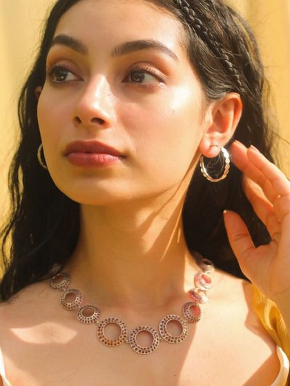 Modeling a contemporary silver necklace and hoops. This shows my versatility in working with modern, minimalist designs in addition to traditional gold temple jewelry.