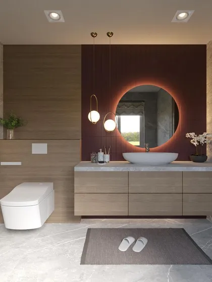I transform bathrooms into personal spas. This design uses a mix of wood-look and marble-textured tiles, a floating vanity to create a sense of space, and a backlit circular mirror that provides a soft, flattering glow.