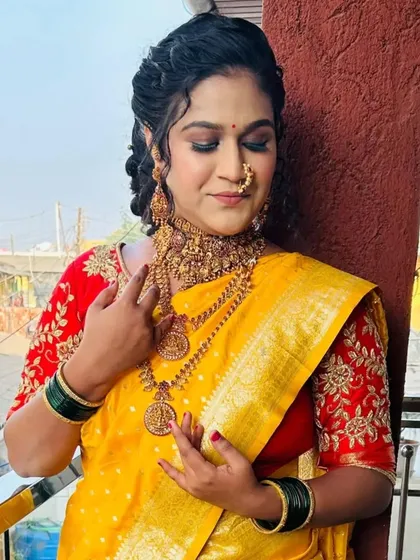 A radiant bride ready for her Haldi or wedding ceremony in a yellow silk saree. The look is completed with heavy temple-style jewelry and a flawless makeup base.