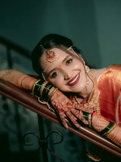 The joy on her face says it all. The makeup is radiant and fresh, with a pop of color on the lips that brings the whole look to life.