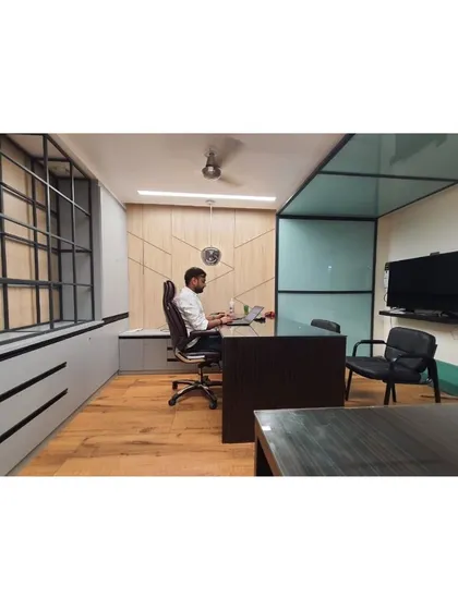 This is a private office cabin I designed for a client, Mr. Vishesh. The space balances a minimalist aesthetic with functional elegance, using clean lines, natural wood flooring, and a glass partition to create an executive workspace that is both open and private.