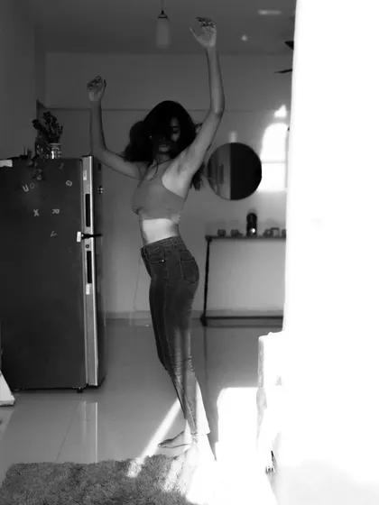 An indoor series using shadows from a window to create patterns on the subject. This shows a creative approach to using natural light in a domestic setting.