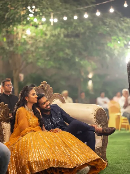 The couple enjoying the performances at their Sangeet. I design comfortable and regal seating for the bride and groom, ensuring they have the best view of the stage and feel like royalty.