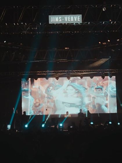 The full stage setup at JIMS Verve in Delhi, showcasing the large LED screen and lighting rig I use for my campus shows.