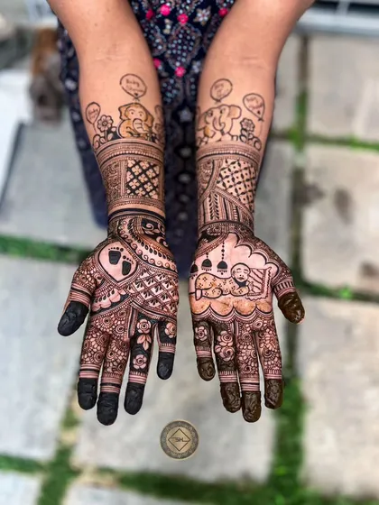 A fun and whimsical baby shower mehendi for Sanmita. The design includes cute cartoon elephants with thought bubbles, a baby sleeping in a cradle under a mosque, and a tiny footprint inside a heart.