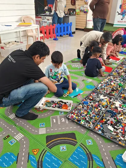 Building together creates the strongest bonds. A father and son work as a team during one of our workshops, sharing a moment of focus and fun. These sessions are perfect for quality family time.