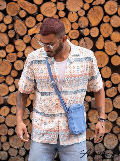 This image captures a candid-style moment from a street fashion shoot. The downward glance and relaxed posture give it an authentic, unposed feel.