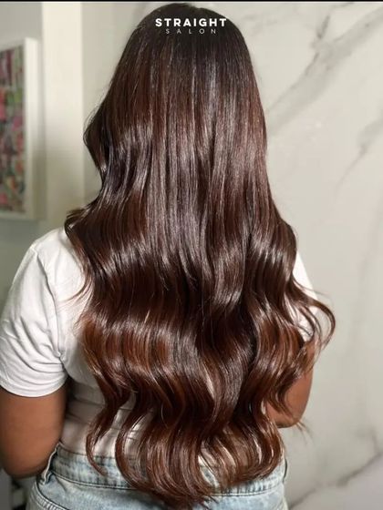 A full shot of the long, glossy hair against a marble backdrop.