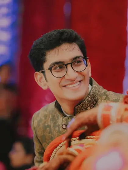 Candid moments, genuine smiles. The groom's brother or a close friend looking on with a happy, proud smile during the ceremony.