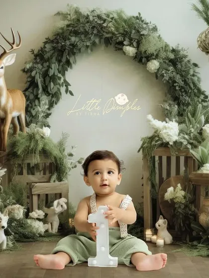 Our new woodland theme is a favorite. This setup with deer, greenery, and rustic elements creates a magical forest scene right in the studio.