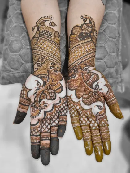 A black and white edit of the peacock bridal mehendi, which emphasizes the intricate line work and shading details in the design.