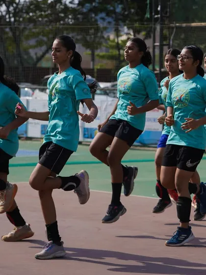 The girls' team doing dynamic warm-ups, building agility and coordination before practice begins.