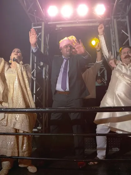 Hands in the air. This is a moment of pure, uninhibited celebration during the groom's procession. The lights, the music, the energy, it's all electric.