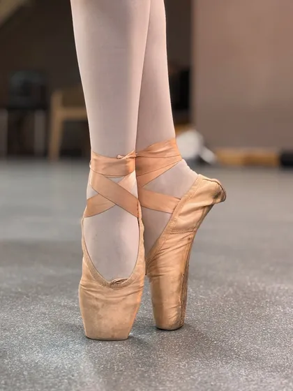 The journey to dancing en pointe is a true test of a ballerina's strength and dedication. This is a close up of our student's pointe shoes, which represent years of hard work, discipline, and the beautiful artistry of advanced ballet.