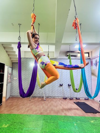 The joy of flight. This pose requires upper body strength to hold, core engagement for stability, and a spirit of playfulness. It's a perfect example of how we make fitness fun.