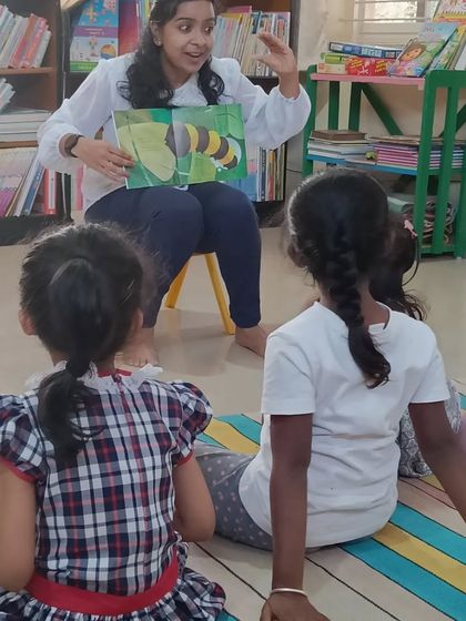 The children are fascinated by the story of a caterpillar's transformation. We often use stories about nature to teach kids about the world around them in an enchanting way.