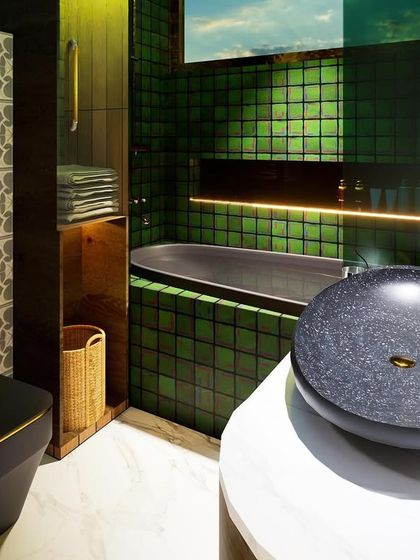 This moody and luxurious bathroom is another intern's design. It combines a dark palette of green tiles and black ceramics with brushed bronze fittings and patterned tiles to create a vintage yet modern feel in a 70 sq.ft. space.