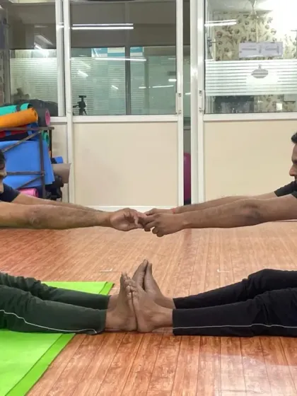Two of our male students working together in a partner stretch. This helps improve flexibility in the back and hamstrings while building a sense of camaraderie in the class.