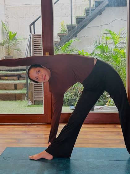 A demonstration of Triangle Pose, focusing on opening the chest and stretching the side body.