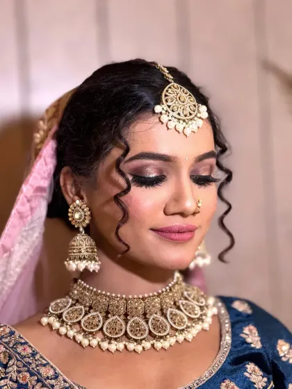 This side profile shows the beautiful dimension of the eye makeup and the soft curls in her hair, a popular choice for pre-wedding events.