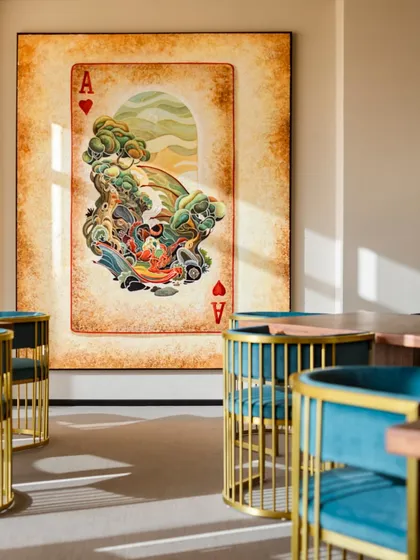 Art can give a space its soul. This oversized, whimsical playing card artwork adds a bold and playful statement to this lounge area, creating a memorable focal point and infusing the room with personality.