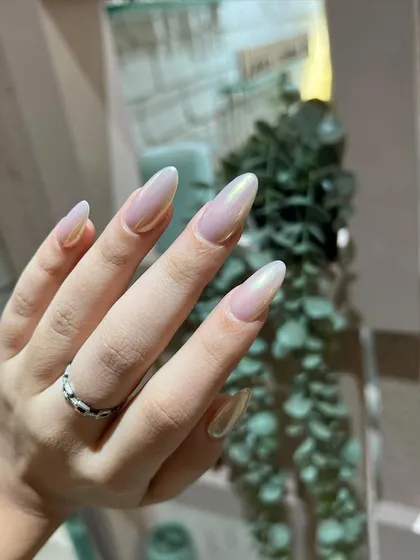 A beautiful glazed or chrome-effect polish in a soft, pearlescent nude. This "glazed donut" look is trendy, subtle, and incredibly chic.