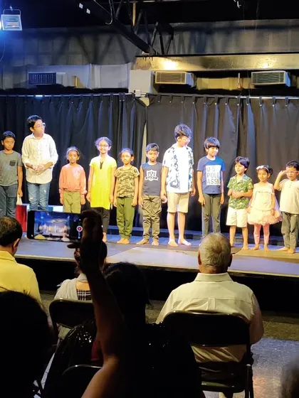 The proud cast of our children's theatre class taking a bow after their successful, self produced show.
