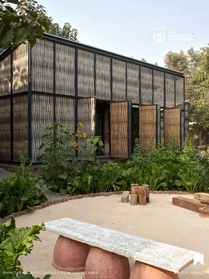 The exterior of the Artist Residency at Farm8, where operable bamboo screens form the building's skin. These panels can be opened to completely merge the interior studio with the surrounding garden, creating a truly inside-out living and working experience.