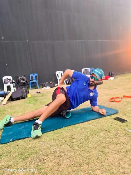 The work does not stop. Here I am on the field using a foam roller on my IT band as part of my own recovery and prehab routine.