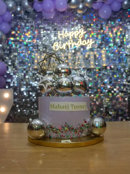 Even the cake was on theme! This gorgeous disco-themed cake with silver disco balls was the perfect centerpiece for the dessert table at Mahati's 7th birthday.