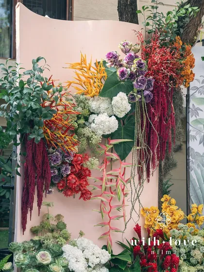A vibrant floral installation from the 'Garden of Gaia' baby shower, showcasing a rich palette of colors and textures.