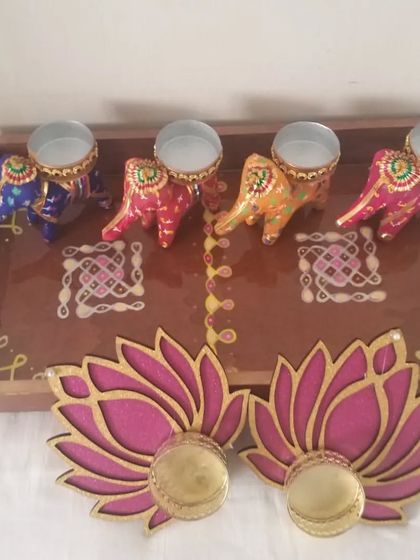 A grand festive hamper featuring a large tray, four colorful elephant T-light holders, and two lotus T-light holders. This makes for a stunning and generous gift for special occasions.