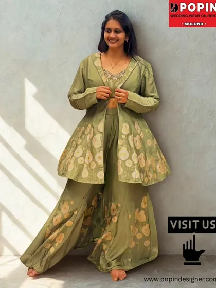 Modern style meets traditional charm in this chic olive green plazo set. The layered jacket adds a contemporary twist, making it a versatile rental for a mehendi, sangeet, or any festive party.
