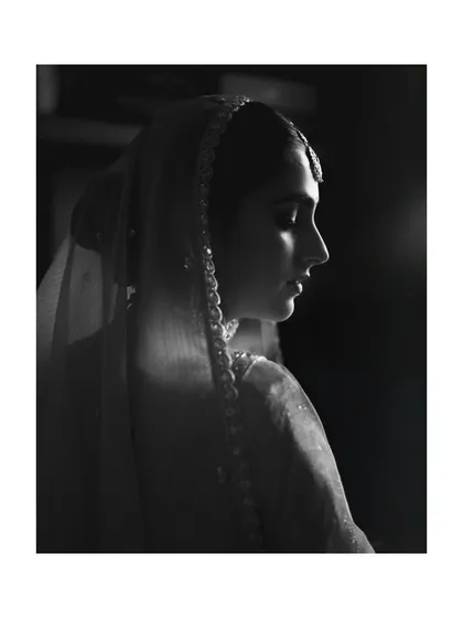 A dramatic black and white profile shot of the bride, capturing her grace and poise.