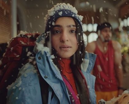 A shot from the Arihant app ad showing a character in a winter scene. I used makeup to create a slightly flushed, cold-weather look that was believable on camera.