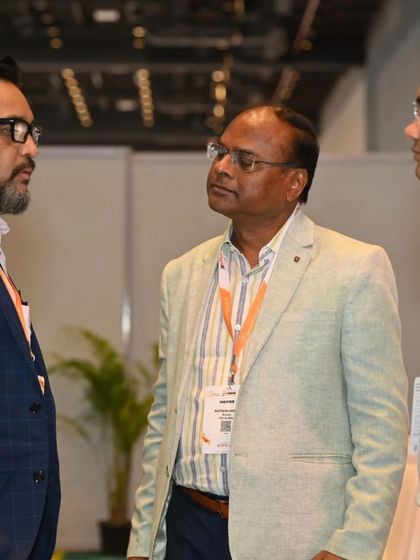 A candid shot of three industry professionals deep in conversation, highlighting the collaborative spirit we foster at the Smart Home Expo.