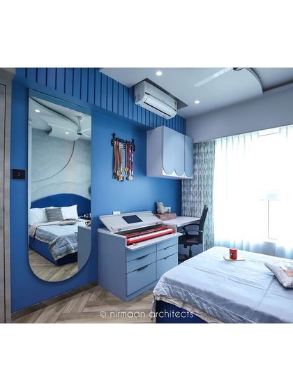 This daughter's bedroom is designed for a music lover, with a dedicated space for her keyboard. The blue color scheme and full-length mirror make the room feel vibrant and spacious.