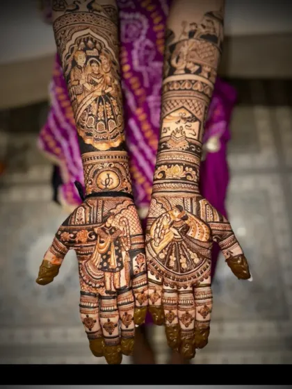 This intricate bridal mehendi features a dancing couple on the palms. The forearms are adorned with a bride's portrait and a scene from a traditional ceremony.