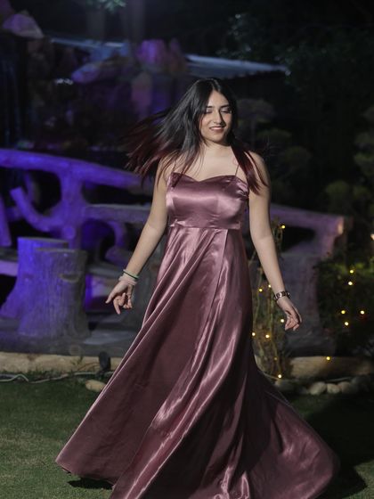 A full-length shot of a beautiful satin gown by The Azmat Official. This content is ideal for showcasing elegant evening wear for formal events.