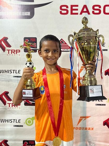 Individual brilliance contributes to team success. One of our U7 champions proudly holds the tournament trophy and his best player award after the PSDL final.