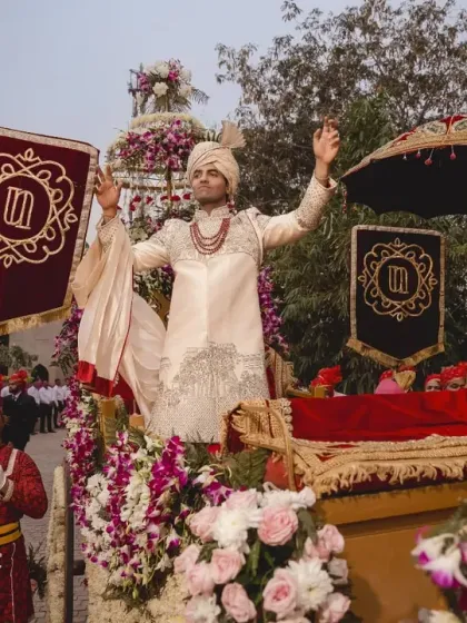 A royal groom deserves a royal entrance. This baraat was designed with a regal carriage and attendants, complete with custom flags bearing the couple's wedding monogram for a personalized touch.