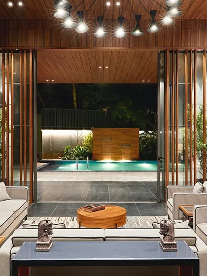 We designed this garden lounge for The Bandra Project to seamlessly connect indoor luxury with serene outdoor living, creating a private, versatile space for residents that opens directly to a leisure pool.