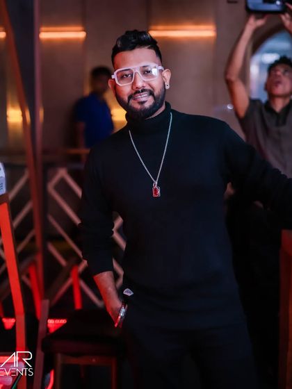 A smiling pose in a black turtleneck. I believe in lighting my own fire.