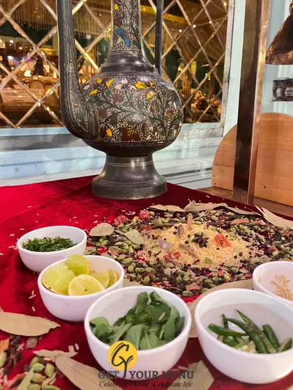 A display of whole spices and fresh herbs next to a traditional jug, showcasing the fresh, aromatic ingredients that are the foundation of my cooking.
