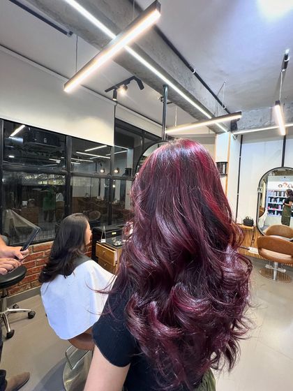 The final look of the no-bleach magenta hair, styled with soft waves to enhance its shine and color.