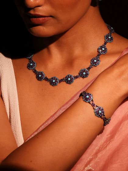 The full Amethyst and Turquoise set worn by a model, showing the cohesive elegance of the necklace and matching bracelet.