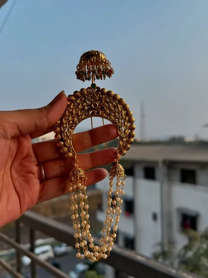 Another view of the 'Khopa' hair pin, held up to show its size and the beautiful pearl chains.